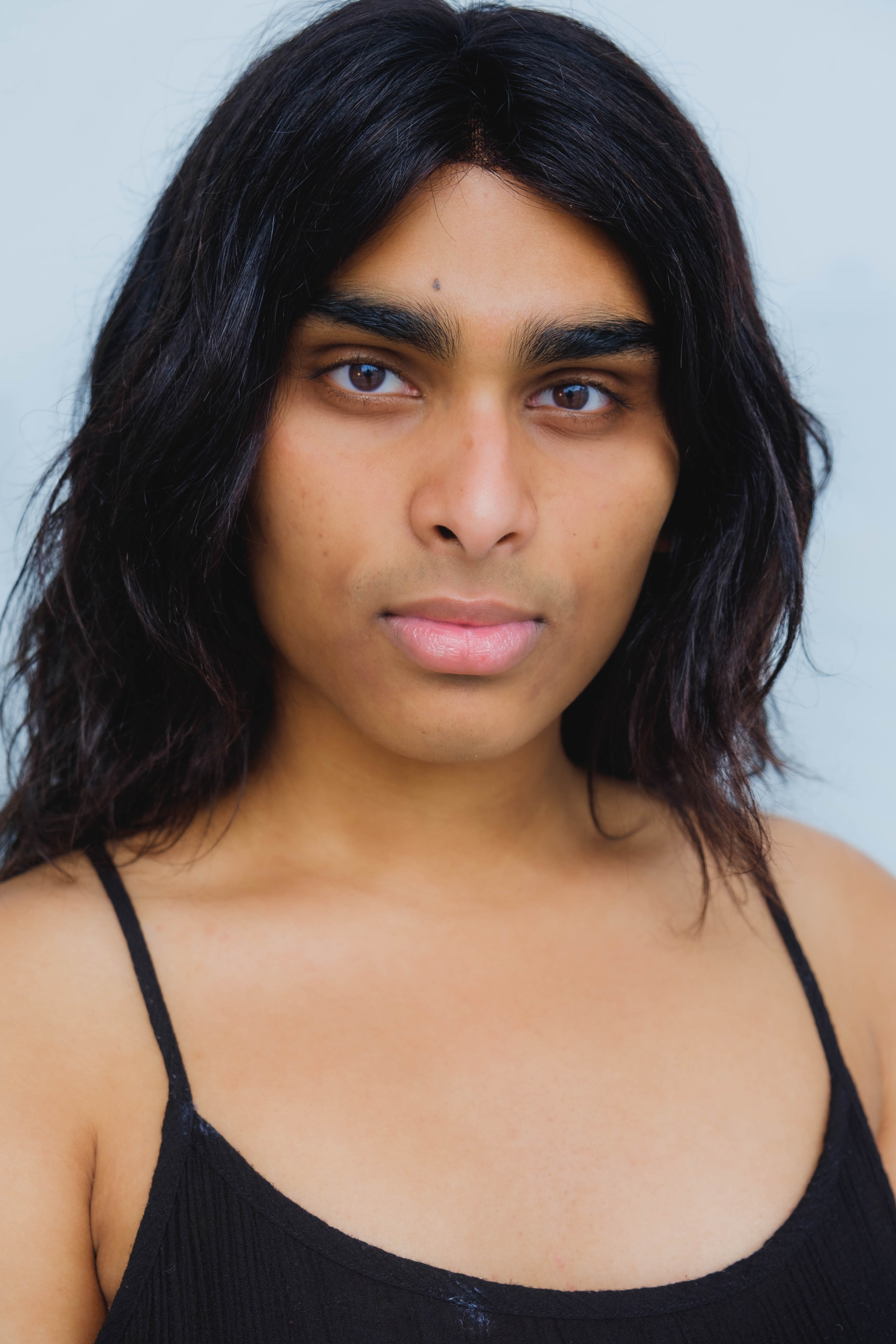 Kiara-Kumail looks intently at the camera.